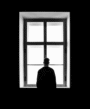 A person standing alone in the window